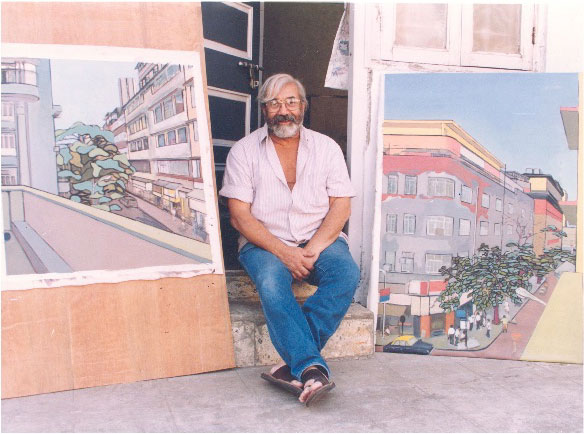 Markand Thakar sitting with two of his paintings.